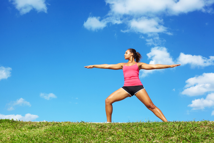 A person jogging outdoors in a sunny park, symbolizing spring training and fitness preparation for summer."