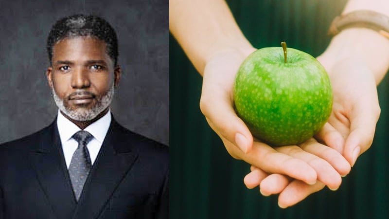 Hands holding a green apple, symbolizing health, wellness, and fresh beginnings for 2026.