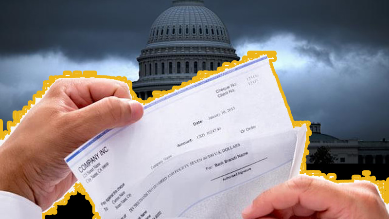 Hands holding a check in front of the U.S. Capitol under a stormy sky, symbolizing financial strain during the federal shutdown.