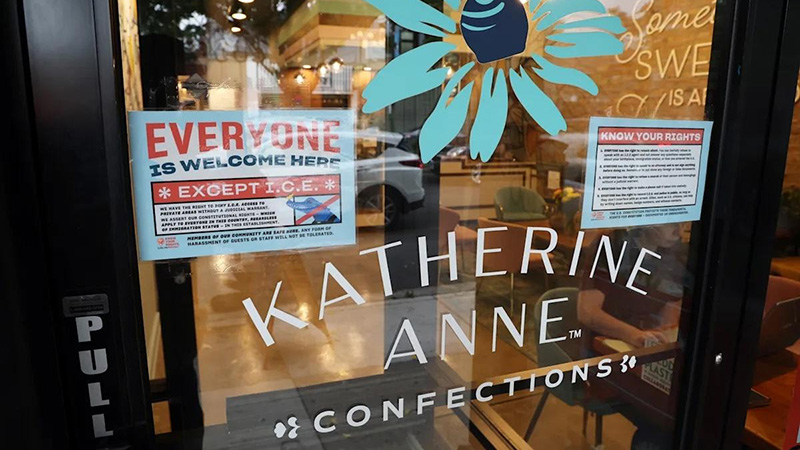 A storefront with a "Everyone is Welcome Here" sign, symbolizing community resistance and solidarity against ICE raids in Chicago.
