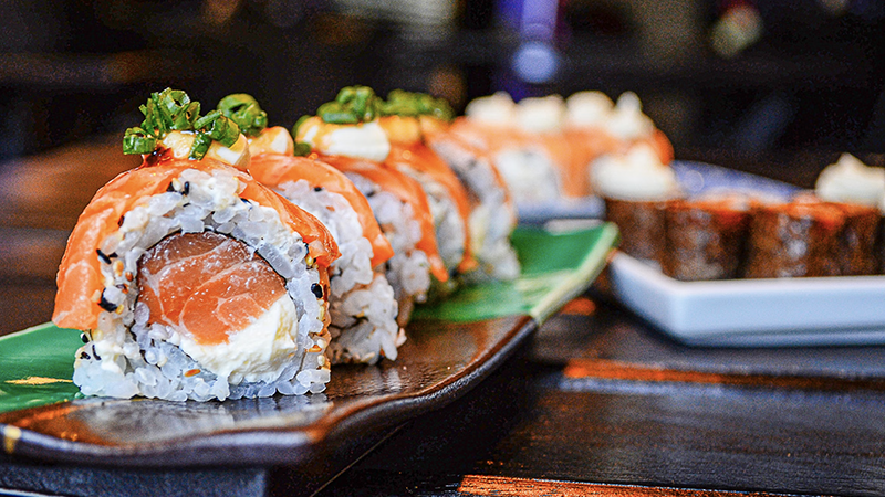 A sushi-making class in progress, showcasing hands-on learning with fresh ingredients and expert guidance.
