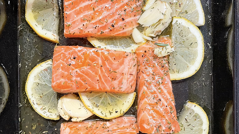 A festive holiday table with modern dishes like shrimp platters, roasted salmon, and colorful desserts, perfect for celebrating with family and friends.