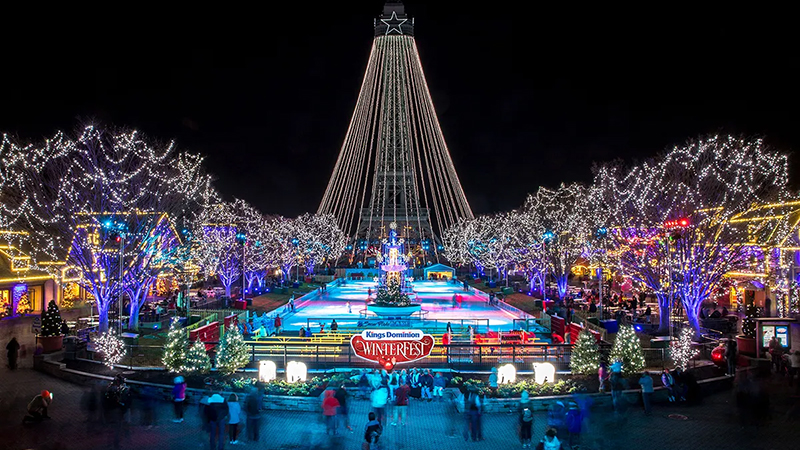 A vibrant nighttime scene of Winter Wonderfest at Nationals Park, featuring a glowing ice rink, festive lights, and a towering illuminated tree.
