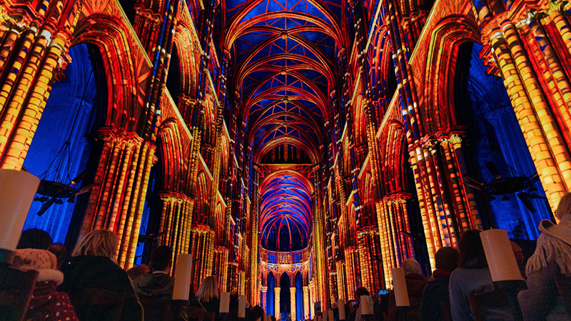 Vibrant light projections illuminate the gothic architecture of a Minneapolis cathedral during the LUMINISCENCE event.