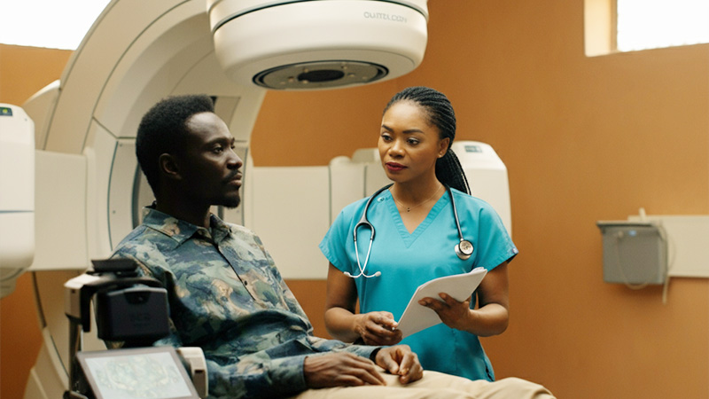 A healthcare worker explaining a cancer treatment plan, highlighting improved survival rate cancer care in low-income communities.