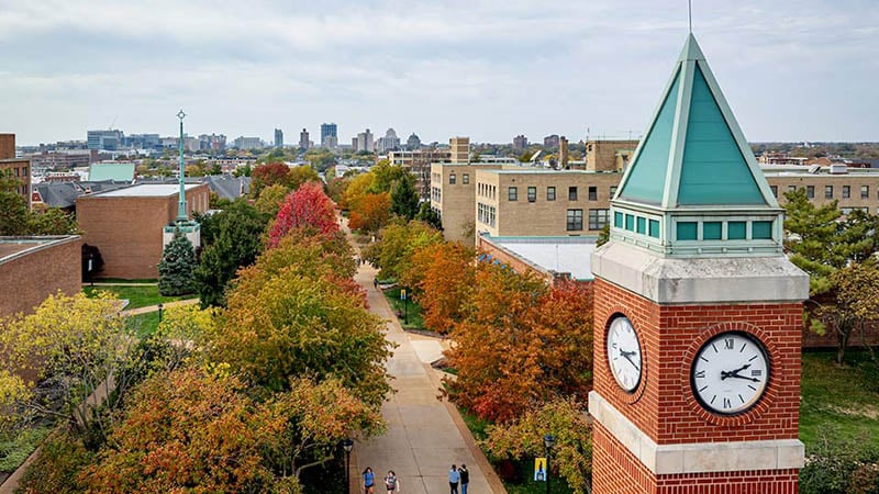 Aerial view of Saint Louis University’s clock tower surrounded by vibrant autumn foliage.