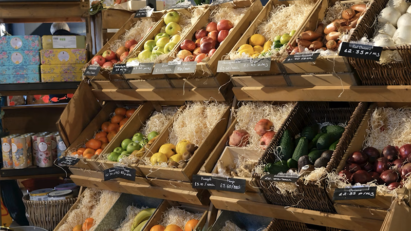 A vibrant Be at Ease Convenience Store showcasing fresh produce, prepared foods, and a welcoming community atmosphere.