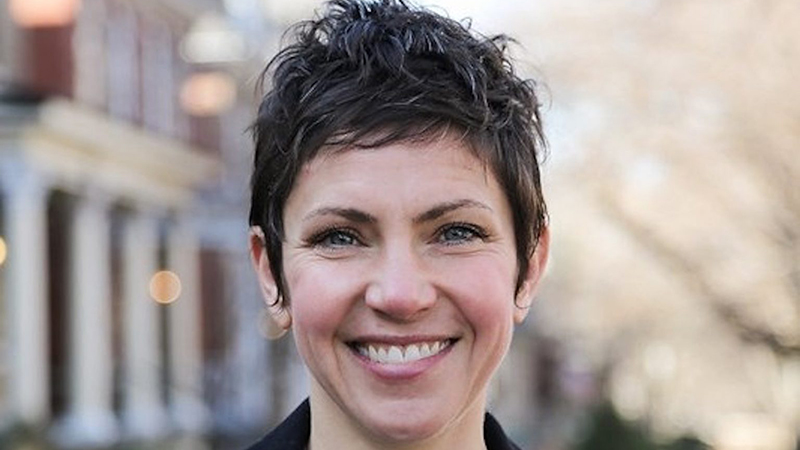 Portrait of Mayor Cara Spencer smiling confidently outdoors.
