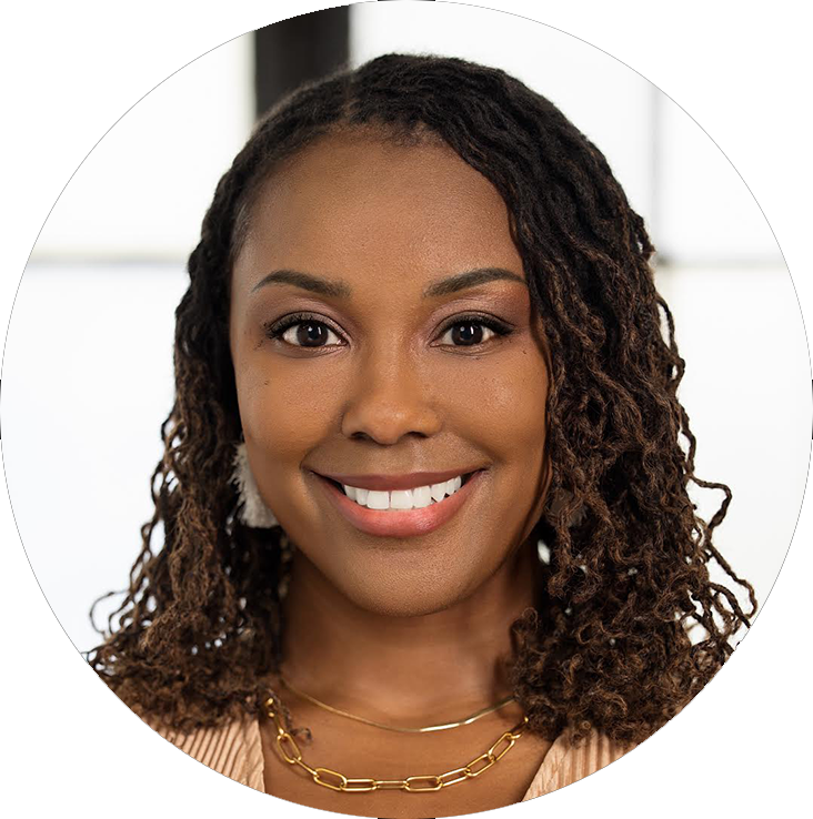 Dr. Andrea Davis smiling in a professional portrait, wearing a champagne pleated top and gold necklaces.