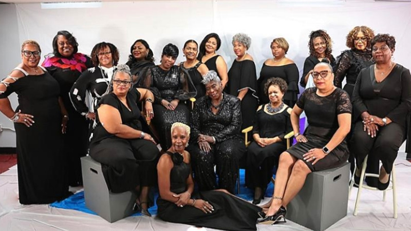 Group photo of African American women in black attire, symbolizing unity and celebration for The Empowerment Network’s Year of the Caregiver.