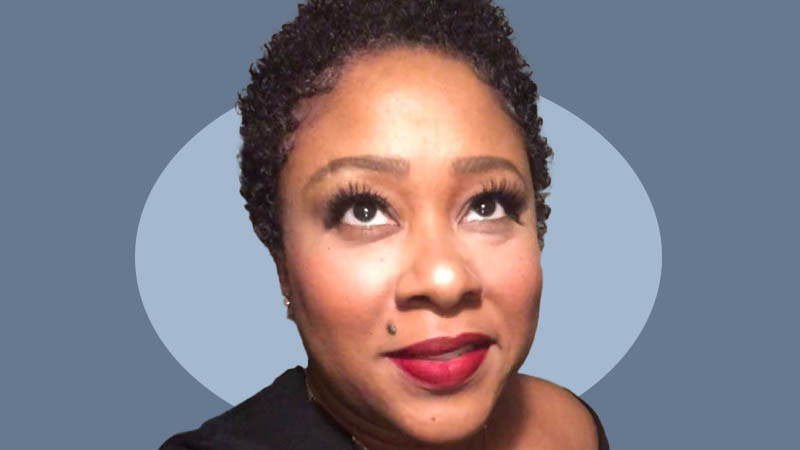 Portrait of Tendai Robin Morris, "The Hair Whisperer," against a two-toned blue background.