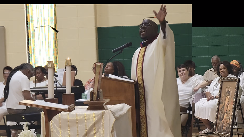 Father Royce Thomas welcoming parishioners at The Rock Church in St. Louis.