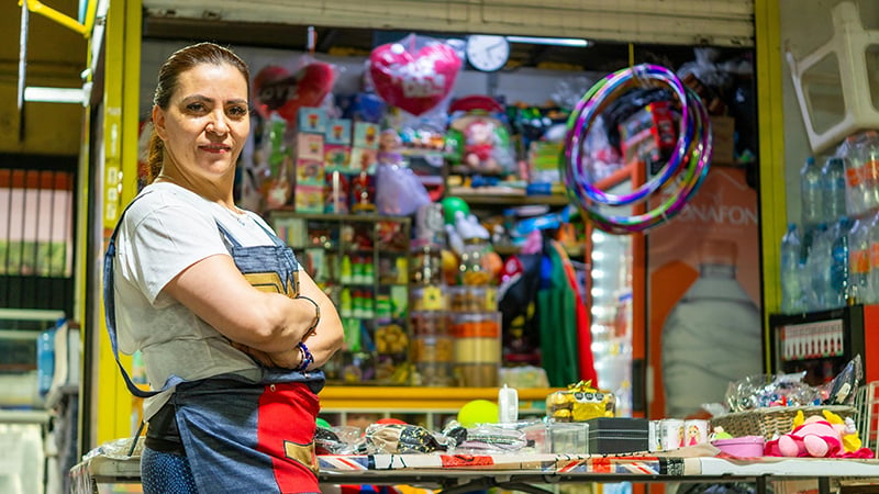 Hispanic business owner discussing strategies amidst immigration policy challenges.