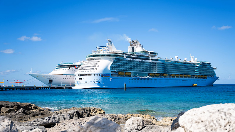 A luxurious cruise ship sailing in turquoise waters under a clear blue sky, symbolizing the best cruise destinations for 2026.