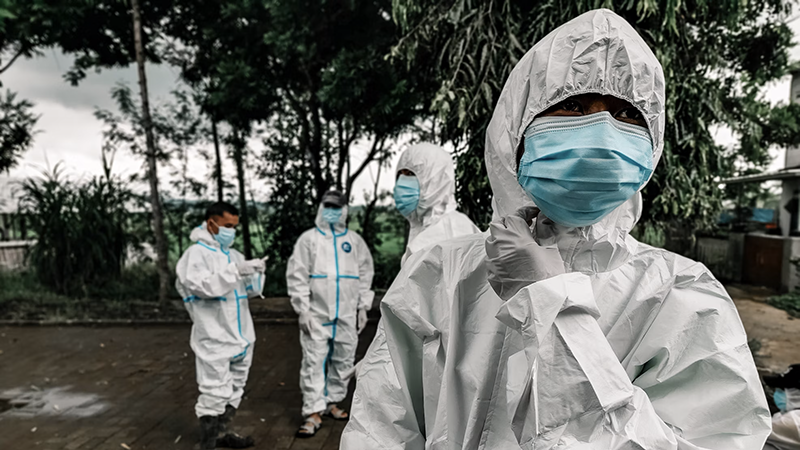 WHO workers in protective suits treating Ebola patients