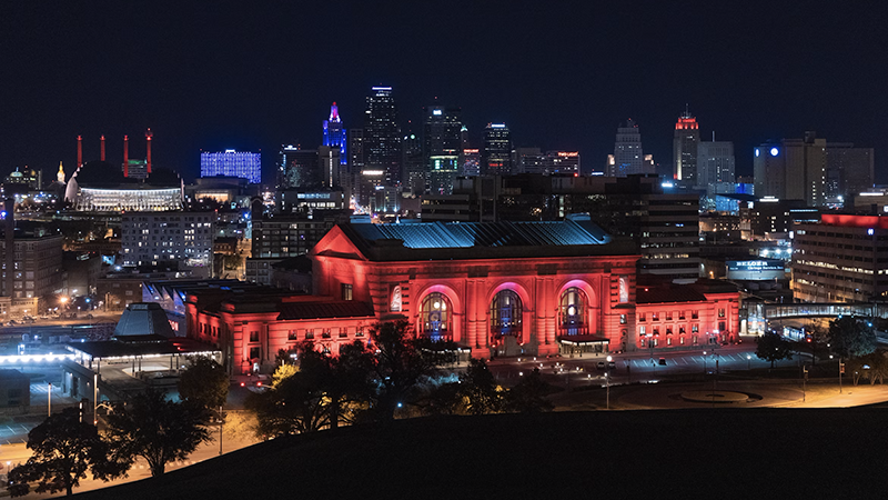 Kansas City skyline with construction cranes, housing icons, and emergency response symbols representing the $1.7 billion ballot package.