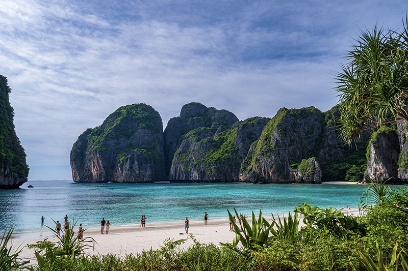 Crystal-clear waters and limestone cliffs of Maya Bay, featured in The Beach.