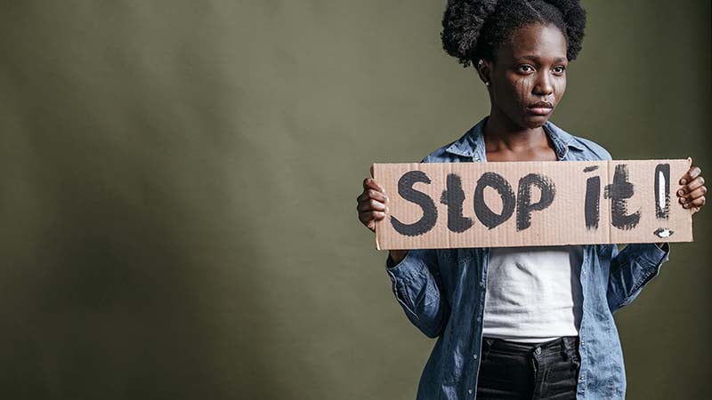 A woman sitting alone in distress, representing the devastating impact of domestic violence in the Black community