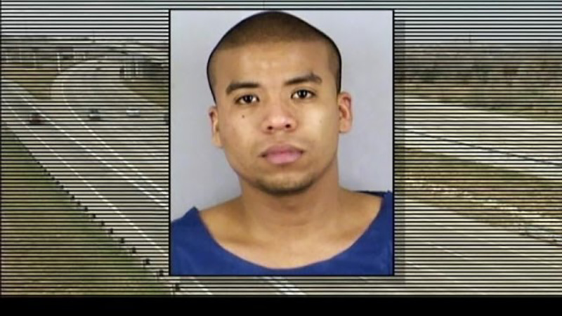 Mugshot of the Kansas City highway shooting suspect set against a graphic television broadcast background featuring a highway curve.