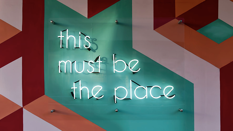 neon signage with "this must be the place" dislayed