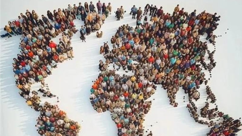 A diverse group of people arranged to form a world map, symbolizing global inclusion and interconnectedness.