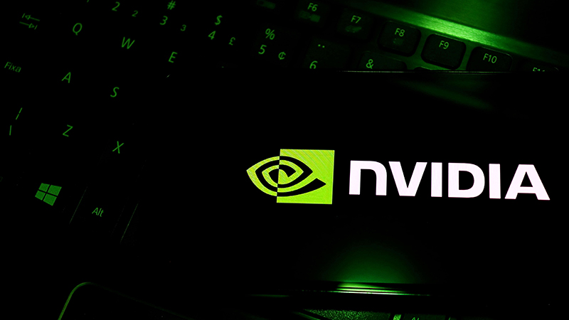 A close-up of a glowing green NVIDIA logo on a screen, symbolizing its dominance in the AI chip market and technological innovation.