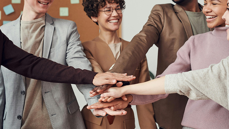 A diverse team collaborating in a modern office, symbolizing inclusion and equity in the workplace.