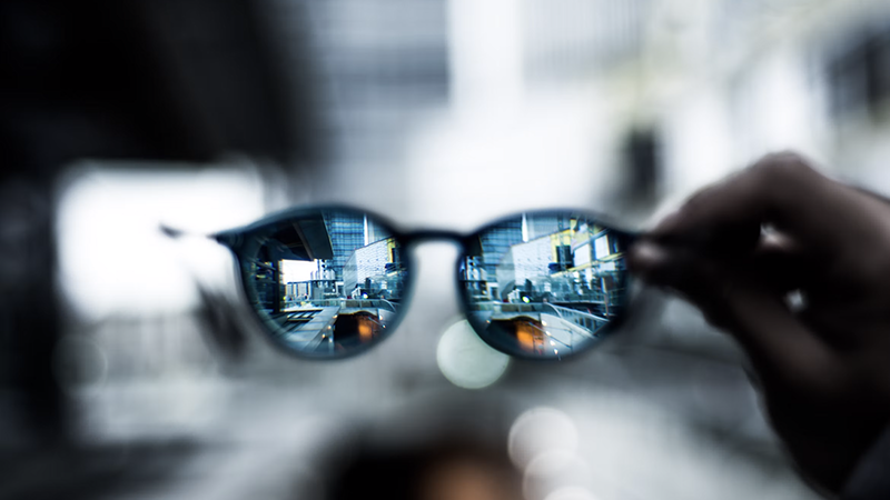 Smart eyewear on an intake desk reflecting local DMV news updates regarding testing privacy rules.