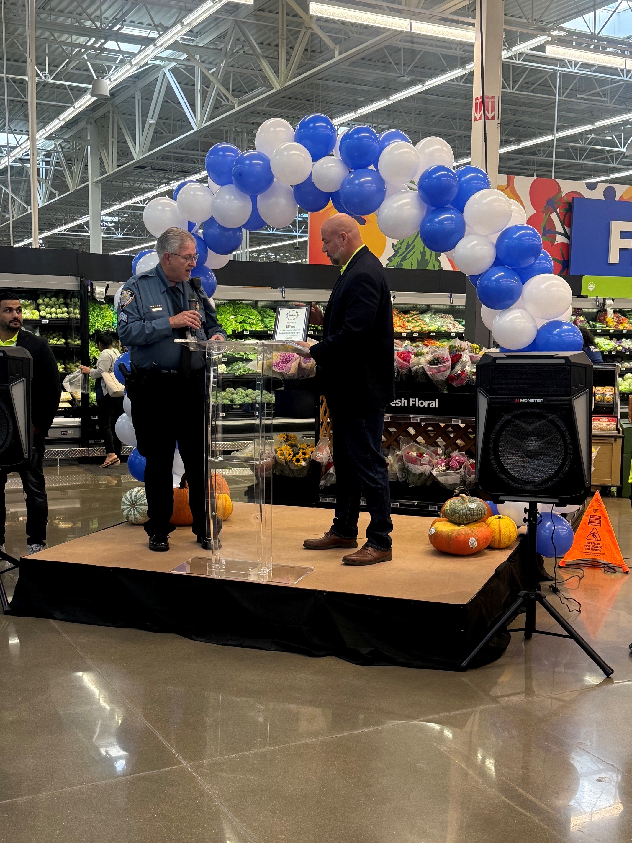 L R Manchester PD Sgt Dan Rehm And Machester Walmart Store Manager Eddie Barron