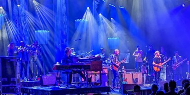 The Tedeschi Trucks Band performing on stage with guitars and full live ensemble.