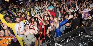 Vibrant group of costumed partygoers celebrating during a downtown Minneapolis nightlife event.