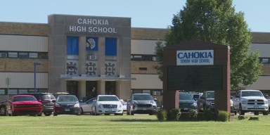 Exterior of Cahokia High School entrance and front lawn with marquee sign in Cahokia, Illinois
