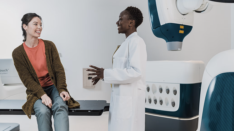 Physician speaking face-to-face with a patient during a clinical consultation