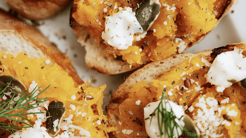 Freshly baked autumn appetizer platter featuring warm melted brie and savory seasonal party bites.