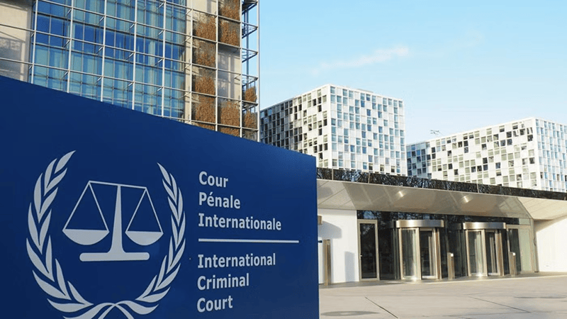 The exterior entrance and modern architectural facade of the International Criminal Court building in The Hague.