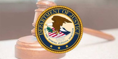 United States Department of Justice seal overlaid on a wooden judge's gavel and sound block in a federal courtroom.