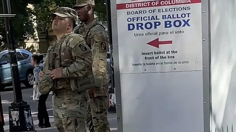 Official municipal mail-in ballot collection box undergoing routine perimeter security checks.