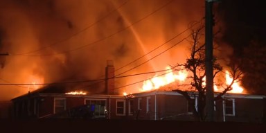 Detroit Fire Department vehicles and personnel responding to a multi-alarm apartment blaze on Webb Street in Russell Woods.