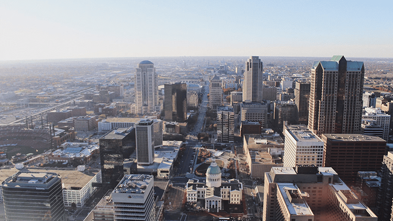 High angle aerial photograph of the St. Louis downtown skyline and riverfront corridor on a clear day