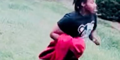 Surveillance photo of fugitive wanted in Maryland Heights officer assault wearing black t-shirt and white sneakers