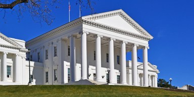 Stamped legal expungement records and laptop showing automated database clearing in Virginia